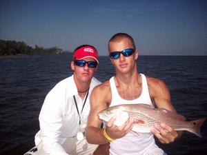 Josh and Captain Brant with a nice red caught in Santa Rosa Sound